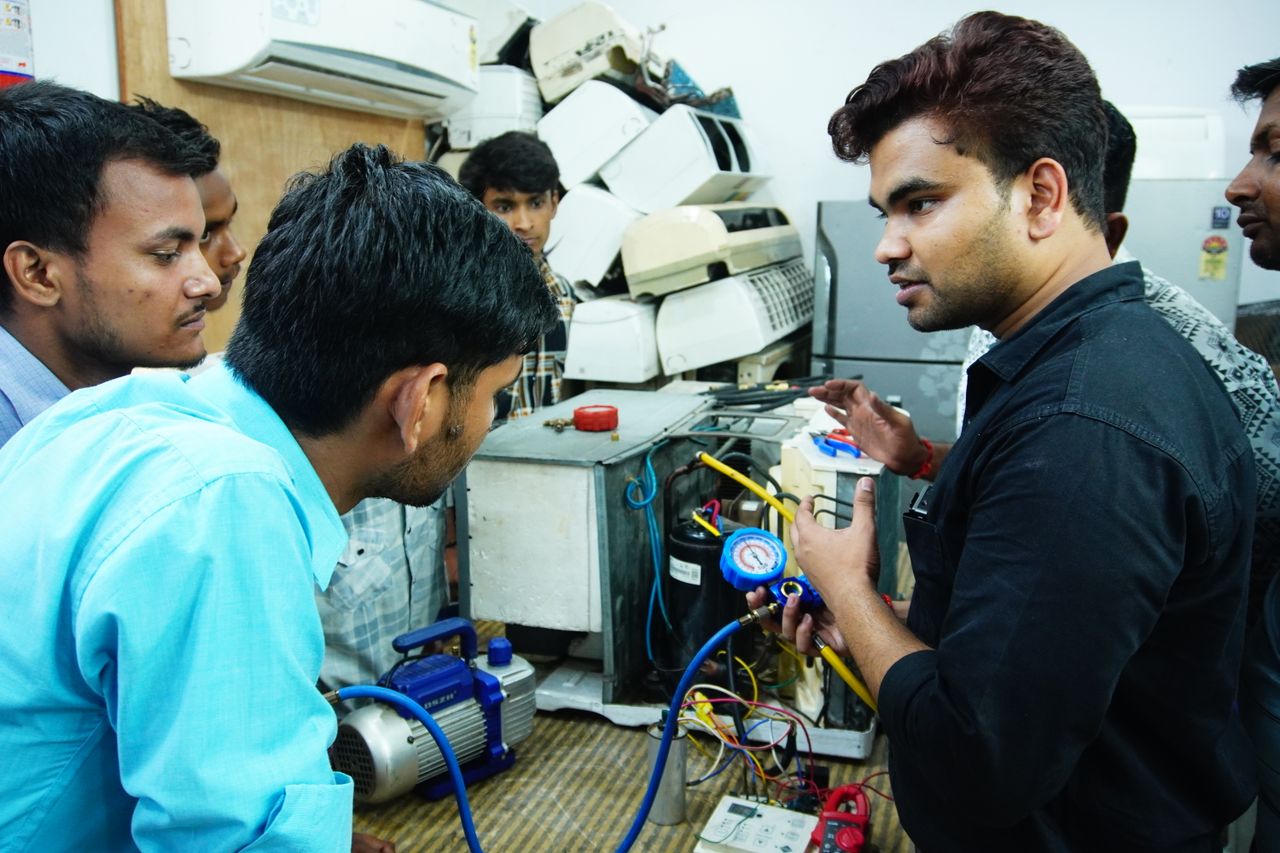services-02 Participants learn AC repair during a hands-on session in Delhi, India.